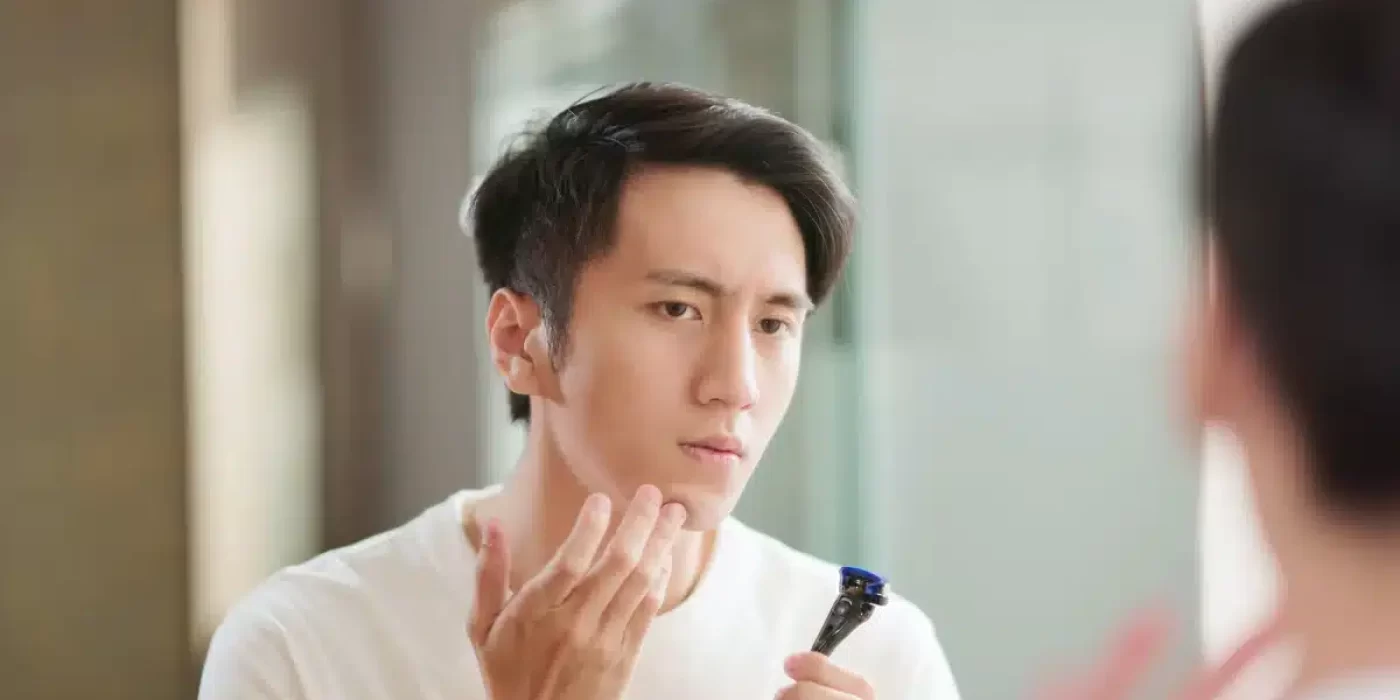 Man achieving irritation-free shave, Close-up of irritation-free shaving products